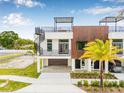 Modern townhome featuring rooftop terrace, spiral staircase, wood accents, and front landscaping at 460 87Th Avenue North, St Petersburg, FL 33702