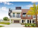 Modern home with a rooftop deck, accented by a spiral staircase, contrasting wood, and black trim at 8631 5Th Street North, St Petersburg, FL 33702