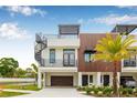 Modern home with a rooftop deck featuring a spiral staircase, contrasting wood, and black trim details at 8631 5Th Street North, St Petersburg, FL 33702