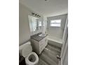Bathroom featuring a modern vanity, updated fixtures, and shower with tub at 3341 Wiltshire Dr, Holiday, FL 34691
