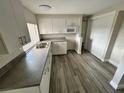Kitchen features white cabinets and stainless steel appliances at 3341 Wiltshire Dr, Holiday, FL 34691
