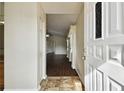Inviting entryway leading to a bright living space with hardwood floors and neutral walls at 37401 Wedgewood Dr, Zephyrhills, FL 33542