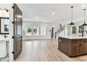 Open-concept living space with lots of natural light, wood-look flooring, and stairs to the second floor at 441 42Nd Ne Ave, St Petersburg, FL 33703