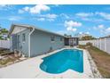 Inviting backyard featuring a sparkling pool and screened-in lanai for outdoor relaxation and entertainment at 4701 Lodestone Dr, Tampa, FL 33615