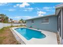 Backyard pool offers a refreshing escape on a sunny day with ample room for lounging and leisure at 4701 Lodestone Dr, Tampa, FL 33615