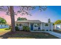 Charming single-story home featuring updated landscaping and a cozy front porch at 7234 12Th N St, St Petersburg, FL 33702