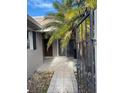 Inviting entrance with tiled walkway, privacy gate and lush tropical landscaping at 439 Boca Ciega Point N Blvd, St Petersburg, FL 33708