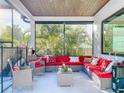 Screened patio with a comfortable seating area and stylish decor, perfect for outdoor relaxation and entertaining at 818 W Adalee St, Tampa, FL 33603
