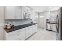 Bright kitchen featuring white cabinets, stainless steel appliances, and a modern design at 3010 59Th S St # 304, Gulfport, FL 33707