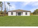 Expansive backyard with lush green lawn and a clean, modern single-story home, ready for outdoor enjoyment at 3560 Bellefonte Ave, North Port, FL 34286