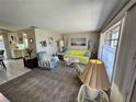 Inviting living room featuring cozy seating, art, and natural light from the window at 3722 Haven Dr, New Port Richey, FL 34652
