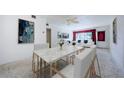 Inviting living room featuring a marble dining table, white furnishings, and stylish decor at 4154 57Th N St # 173, Kenneth City, FL 33709