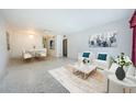 Bright living room with white sofas, blue accents, and an adjacent dining area at 4154 57Th N St # 173, Kenneth City, FL 33709