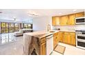 Bright kitchen with natural wood cabinets, marble countertops, and stainless steel appliances at 5400 Park N St # 209, St Petersburg, FL 33709