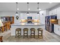 Bright kitchen featuring a large island with pendant lighting, stainless steel appliances, and modern finishes at 6216 Kevesta Ave, Palmetto, FL 34221