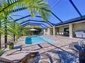 Inviting screened-in pool with brick patio, lounge chairs, outdoor seating, and grill for relaxing and entertaining at 11525 Lake Lucaya Dr, Riverview, FL 33579