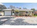 A charming single story home with a well manicured front yard and front-facing garage at 2951 Bay View Dr, Safety Harbor, FL 34695