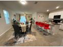 Open-concept living room and dining area features modern decor and a breakfast bar at 16949 Secret Meadow Dr, Odessa, FL 33556