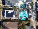 A bird's eye view of a home showcasing a well-maintained yard, patio with shade sails, and swimming pool at 2528 3Rd N Ave, St Petersburg, FL 33713