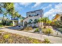 Charming home featuring a stucco exterior, arched windows, and a well-manicured front yard with tropical landscaping at 2528 3Rd N Ave, St Petersburg, FL 33713
