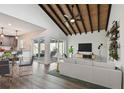 Bright living room featuring a vaulted ceiling, ceiling fan, and sliding glass doors to the outdoor patio at 2734 Sand Hollow Ct # 1, Clearwater, FL 33761