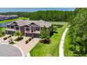 Aerial view of an elegant townhome with pond views and walking trail at 4899 Isola Ct, Wesley Chapel, FL 33543