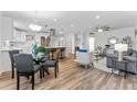 Bright open-concept living and kitchen area featuring modern decor, wood floors, and natural light at 8703 Driftwood Dr, Tampa, FL 33615
