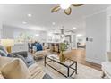 Open-concept living space with updated kitchen, hardwood floors, and stylish decor at 8703 Driftwood Dr, Tampa, FL 33615