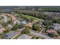 Gorgeous aerial view of the property located on the golf course featuring mature trees at 12700 Grand Traverse Dr, Dade City, FL 33525