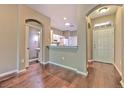 Inviting interior view showcasing hardwood floors, a bathroom, and a glimpse of the kitchen at 18827 Duquesne Dr, Tampa, FL 33647