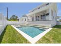 The backyard shows a new pool and spa combination with a spacious yard at 323 Appian Ne Way, St Petersburg, FL 33704