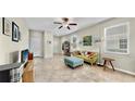 Inviting living room showcases a vibrant sofa, soft ottoman, and a wall of books at 3818 Cat Mint St, Tampa, FL 33619