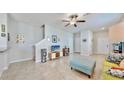 Relaxing living room features a comfy blue ottoman and entertainment center, promoting relaxation at 3818 Cat Mint St, Tampa, FL 33619