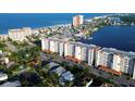Aerial view of condo complex with multiple units, parking, landscaping, and proximity to the beach and waterway at 17717 Gulf Blvd # 601, Redington Shores, FL 33708