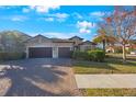 Charming home featuring a three-car garage and a brick driveway at 2564 Grand Cypress Blvd, Palm Harbor, FL 34684