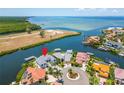 Stunning aerial view of waterfront home with lush landscaping and private dock at 1024 Sonata Ln, Apollo Beach, FL 33572
