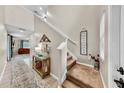 Inviting foyer featuring tile flooring, a staircase, decorative elements, and a view of the living space at 17102 Yellow Pine St, Wimauma, FL 33598