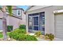 Inviting screened-in front porch with manicured landscaping and an address marker, a great curb appeal at 17102 Yellow Pine St, Wimauma, FL 33598