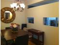 Charming dining room featuring a round mirror, chandelier, and wooden dining set, creating a cozy atmosphere at 501 Knights Run Ave # 2119, Tampa, FL 33602
