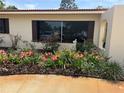 Charming home featuring a beautiful garden with vibrant flowers and a well-maintained lawn at 6226 Hampton N Ct, St Petersburg, FL 33710