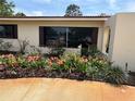 Charming home featuring a beautiful garden with vibrant flowers and a well-maintained lawn at 6226 Hampton N Ct, St Petersburg, FL 33710