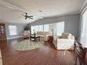 Bright living room with hardwood floors and comfortable seating at 112 Saint Pierres Way, Apollo Beach, FL 33572