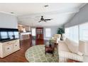 Cozy living room featuring hardwood floors, a ceiling fan, and lots of natural light at 112 Saint Pierres Way, Apollo Beach, FL 33572