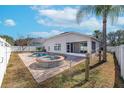 A spacious backyard featuring a pool, spa, screened patio, and a white privacy fence at 2044 Heartland Cir, Valrico, FL 33594