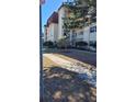 View of a condo building with balconies, landscaping, and sidewalk, creating a welcoming exterior at 209 Ne Lincoln N Cir # 109, St Petersburg, FL 33702