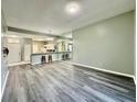 Spacious living room with new gray flooring and a seamless flow into the kitchen area at 2116 Nantucket Dr # 19, Sun City Center, FL 33573