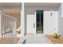 Modern entryway with a white door, side window, and a seating area at 2702 N Woodrow Ave # 2, Tampa, FL 33602