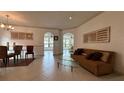 Bright living room with tile floors, chandelier, furniture and ample natural light at 2757 Via Cipriani # 1114A, Clearwater, FL 33764