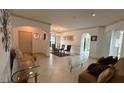 Open concept living room featuring neutral walls, tile floors and archways leading to other rooms at 2757 Via Cipriani # 1114A, Clearwater, FL 33764