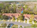 An aerial view showcasing the property's location within a lush, green residential neighborhood at 3985 Mermoor Dr, Palm Harbor, FL 34685